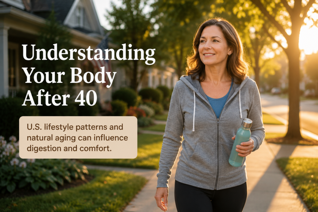 Healthy American woman around age 50 walking through a suburban neighborhood at sunset while carrying a reusable water bottle, representing healthy aging and digestive wellness after 40.